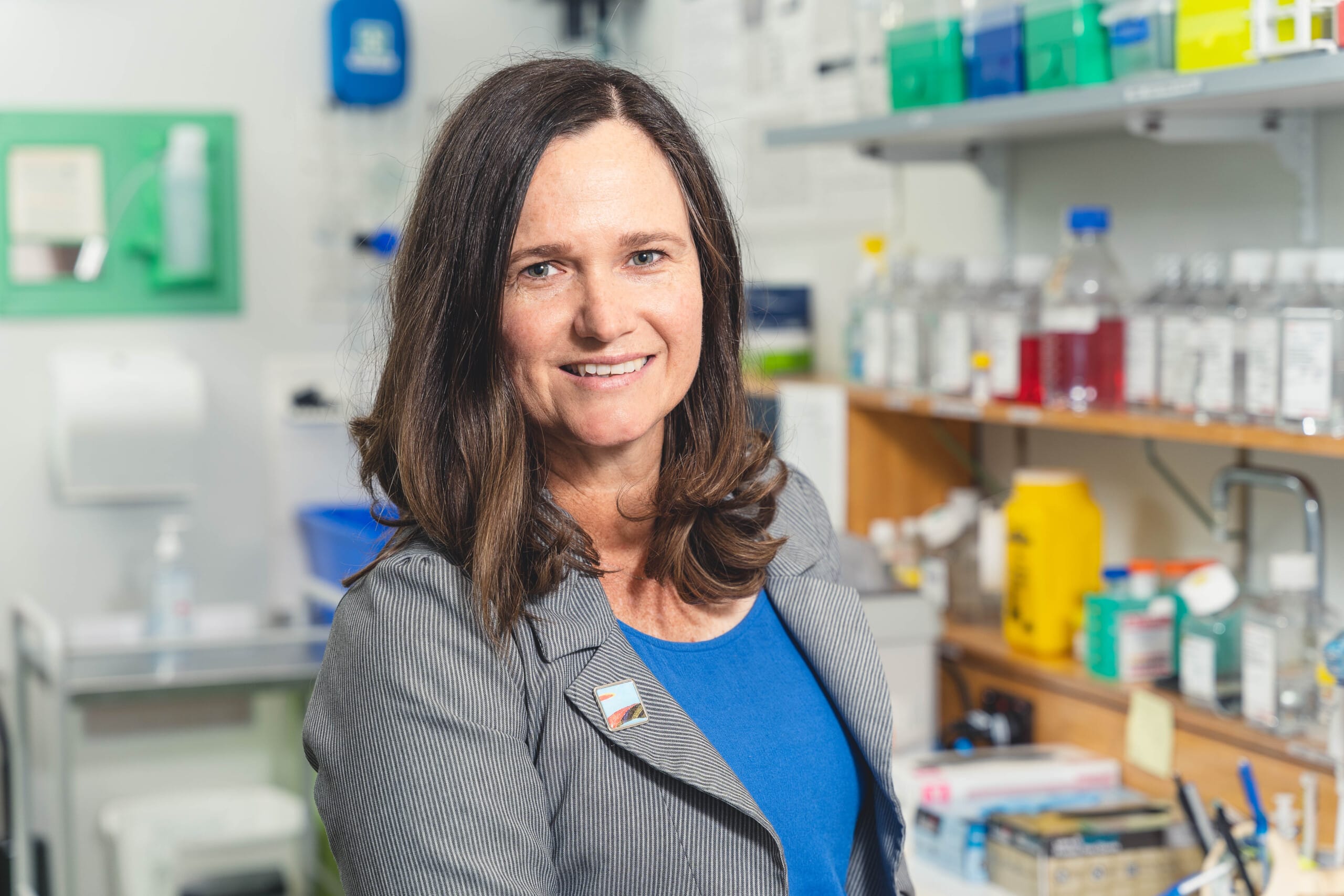 A headshot of Dr Jessup in a laboratory, smiling at the camera